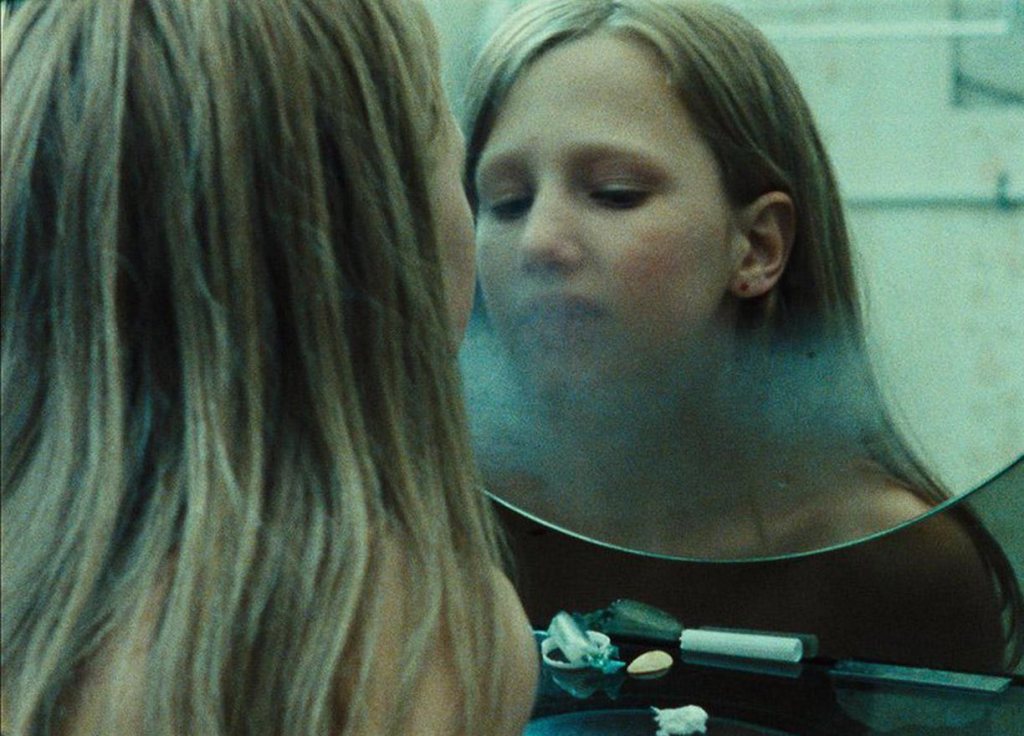 Marta (Yile Yara Vianello) fogging up a bathroom mirror with her breath.