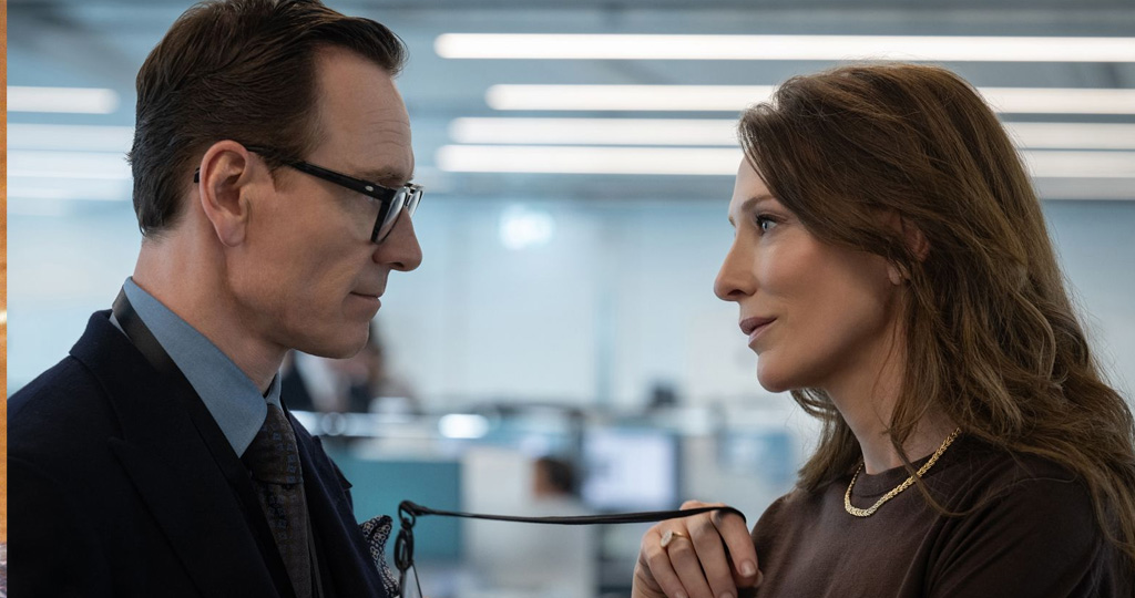 George (Michael Fassbender) and Kathryn (Cate Blanchett) flirting at the office.