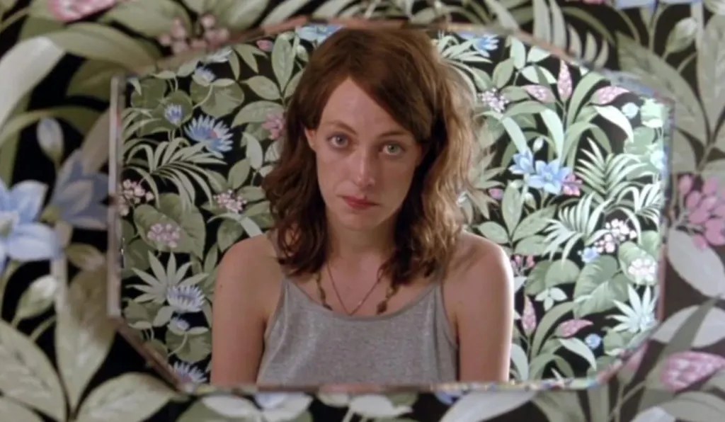 Lily (Loren Taylor) looking at herself in a mirror.