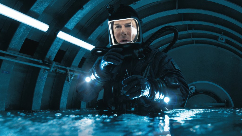 Ethan Hunt (Tom Cruise) in a diving suit on a water-filled submarine.