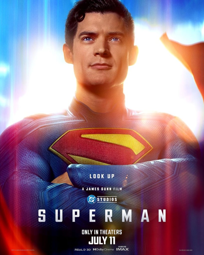 The movie poster showing Superman (David Corenswet) with his arms crossed over his chest.
