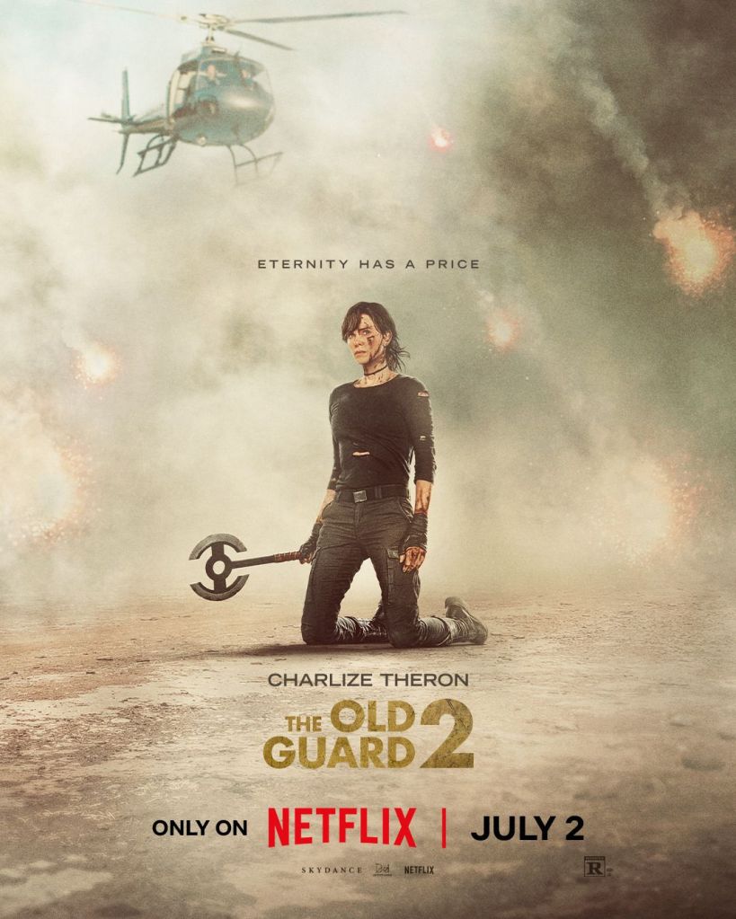 The movie poster showing Andy (Charlize Theron) kneeling in the dust whirled up by a helicopter. She has a bloodied face and an axe in her hand. There are explosions behind her.