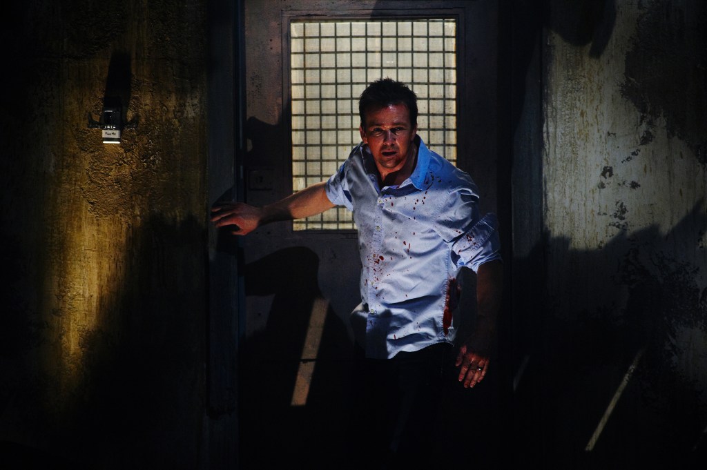 Bobby (Sean Patrick Flanery) in a bloodied shirt looking generally disheveled. 