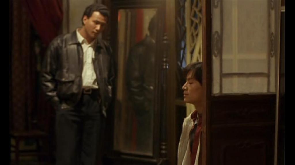 Xiao Shi (Jun Hu) standing over A Lan (Si Han) in the police station.