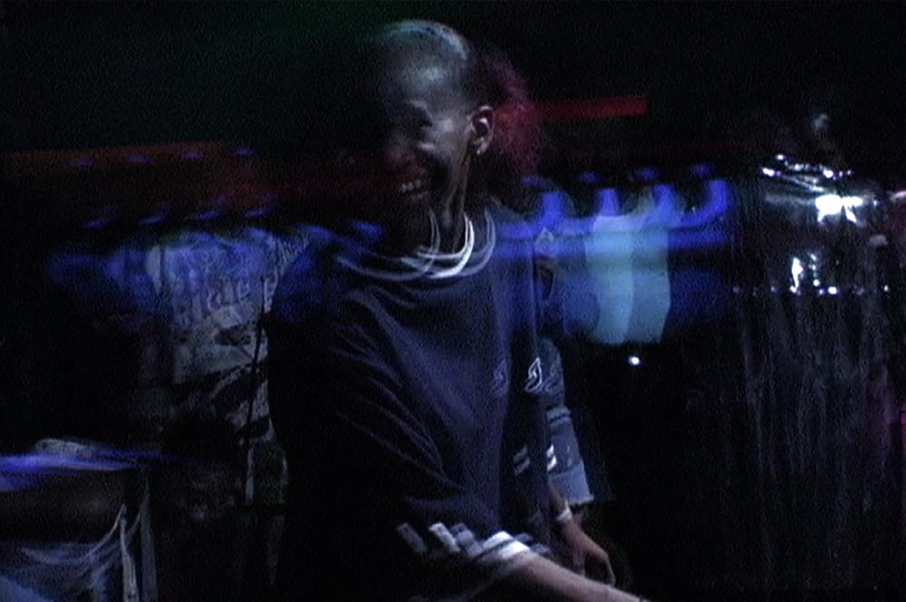 A somewhat fragmented image of a smiling woman.