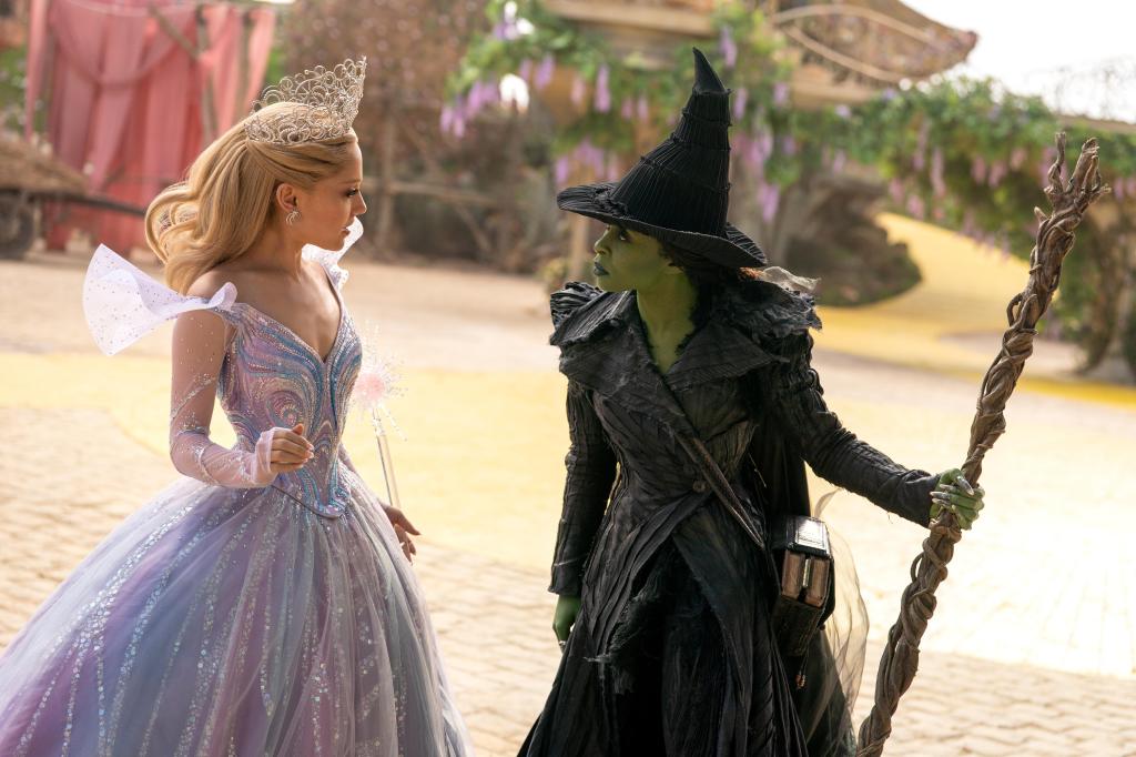 Glinda (Ariana Grande) and Elphaba (Cynthia Erivo) facing off in a town square.