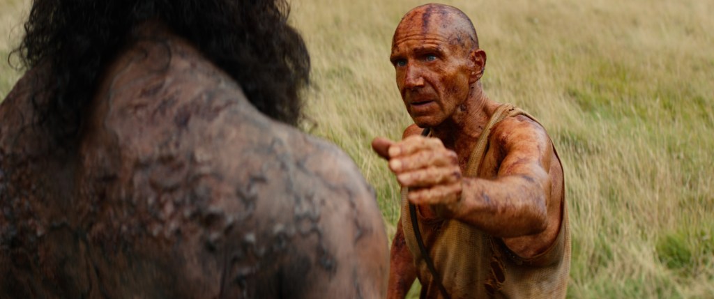Kelson (Ralph Fiennes) reaching for Samson (Chi Lewis-Parry).