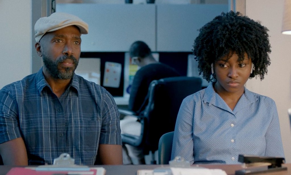 Walter (Ntare Guma Mbaho Mwine) and Sylvia (Jayme Lawson) sitting in her school, talking to an official.