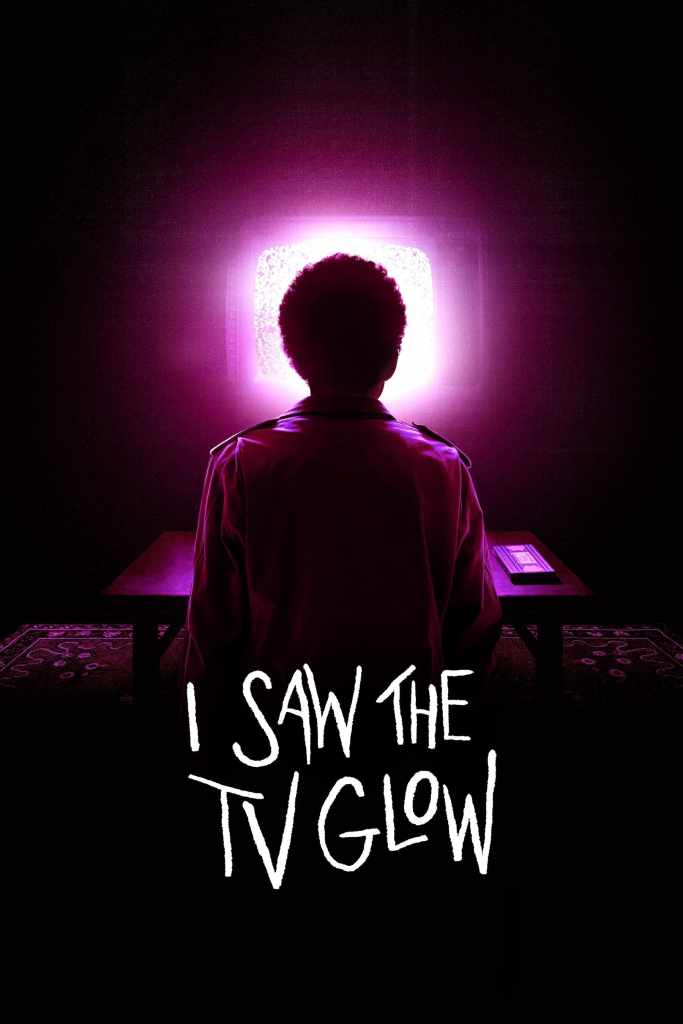 The movie poster showing Owen (Ian Foreman) from behind as he is looking at a pinkly glowing TV. A video tape lies on the table in front of him.