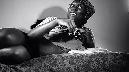 Liyah Mitchel lounging informally on her bed, smiling. 