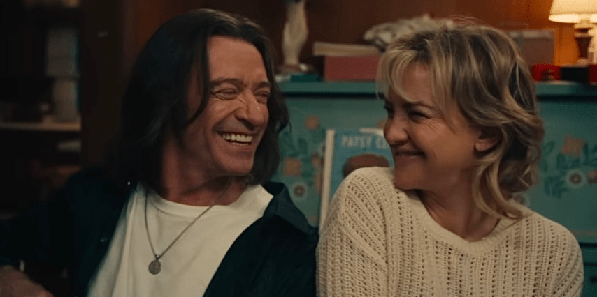 Mike (Hugh Jackman) and Claire (Kate Hudson) smiling happily at each other.