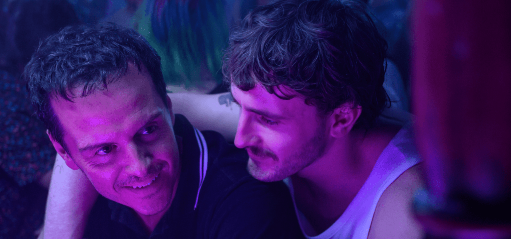 Adam (Andrew Scott) and Harry (Paul Mescal) at a club, leaning against a bar. Harry has his arm around Adam's shoulder.