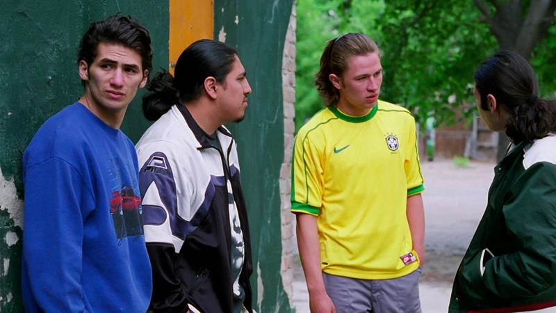 Can (Tamer Yigit) and three other young men who deal standing at the entrance to a park.