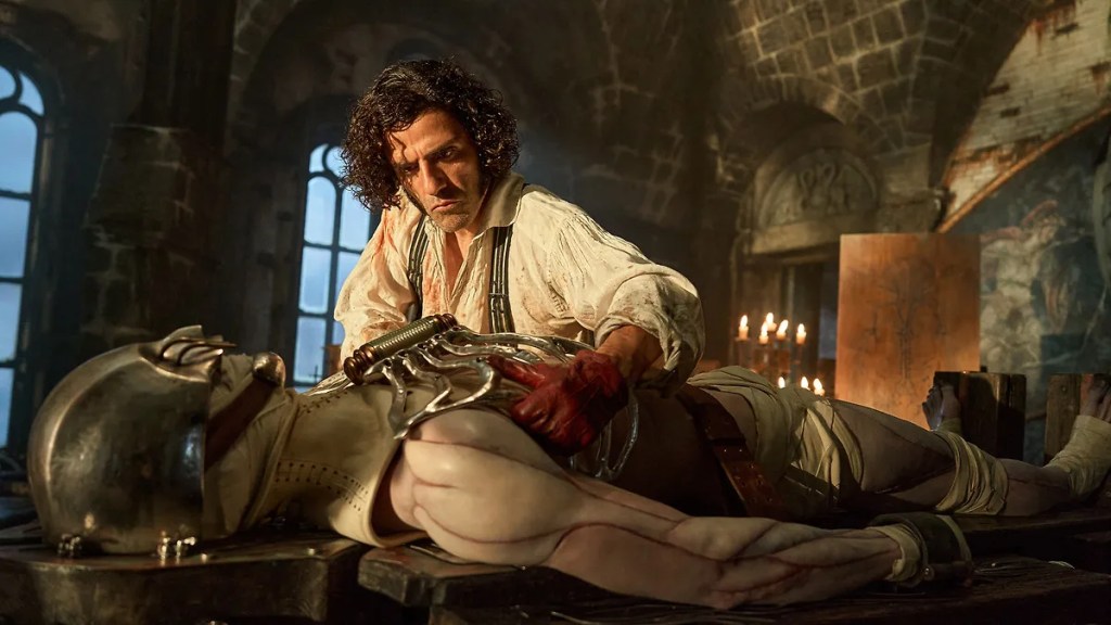 Victor Frankenstein (Oscar Isaac) working on his Creature (Jacob Elordi). 