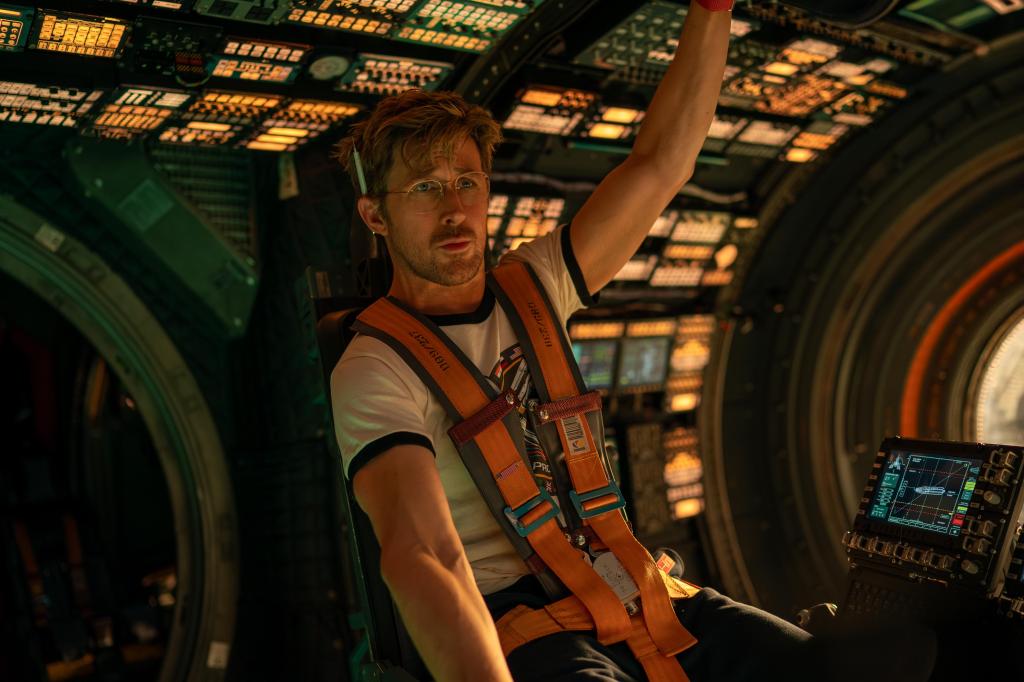 Ryland (Ryan Gosling) sitting in the pilot chair on the spaceship.