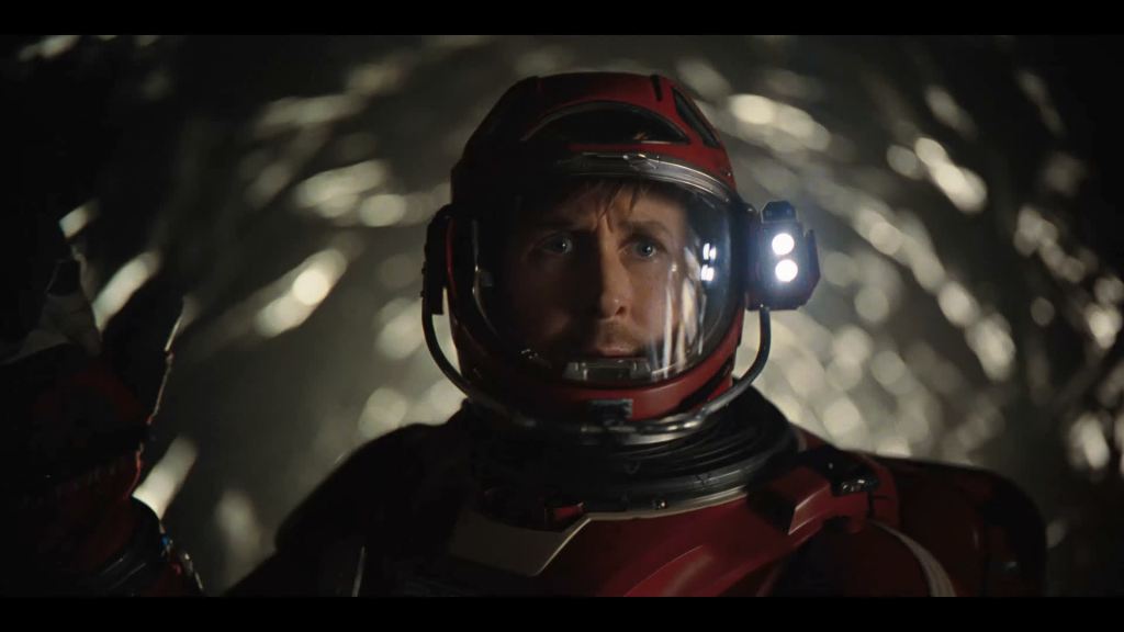 Ryland (Ryan Gosling) in some kind of tunnel, wearing a space suit.