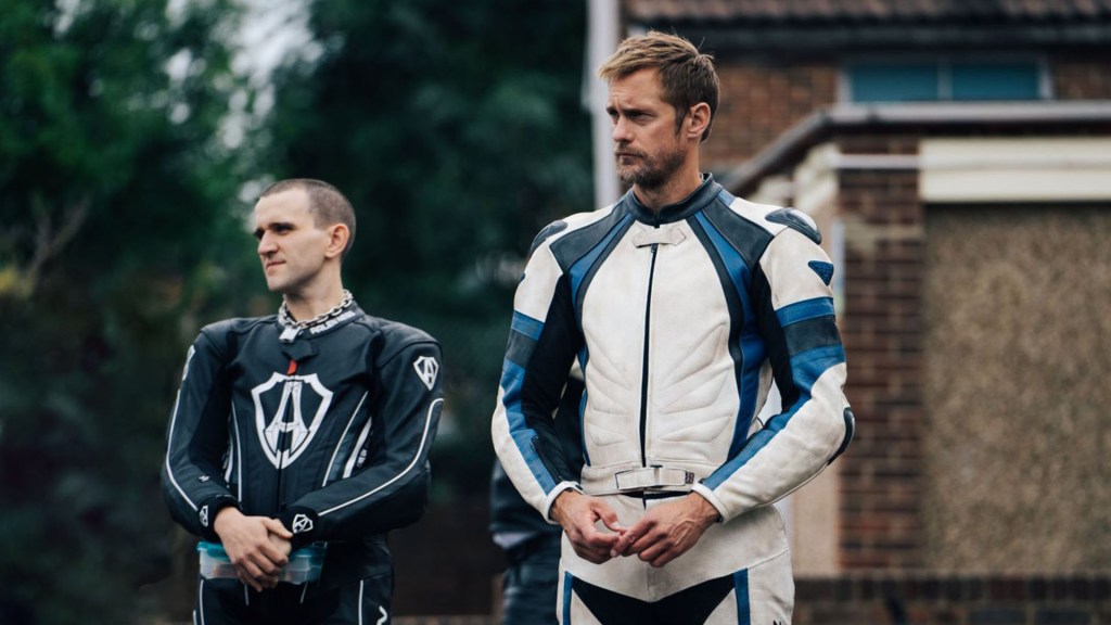 Colin (Harry Melling), his hair now cut short and wearing biker gear, and Ray (Alexander Skarsgård), also in biker gear, looking in the same direction.