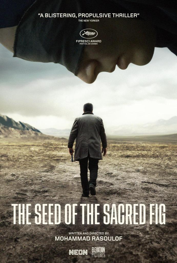 The movie poster showing the horizontal face of a blindfolded woman looking down on Iman (Missagh Zareh) who is walking through the desert with a gun in his hand, is back turned to the audience.