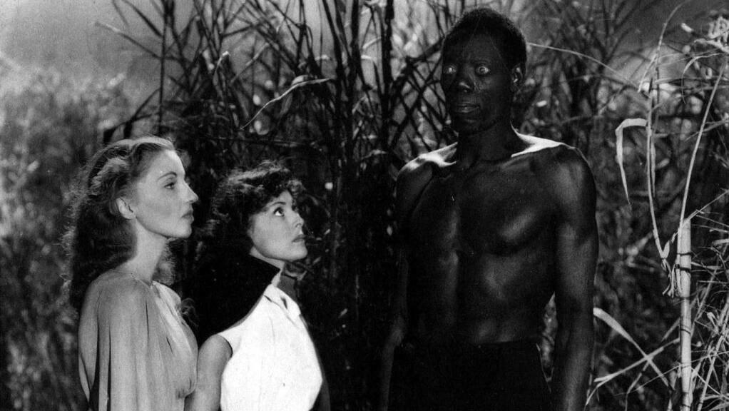 Jessica (Christine Gordon) and Betsy (Frances Dee) facing a tall Black man with bulging eyes (Darby Jones) in a field. He is staring past them.