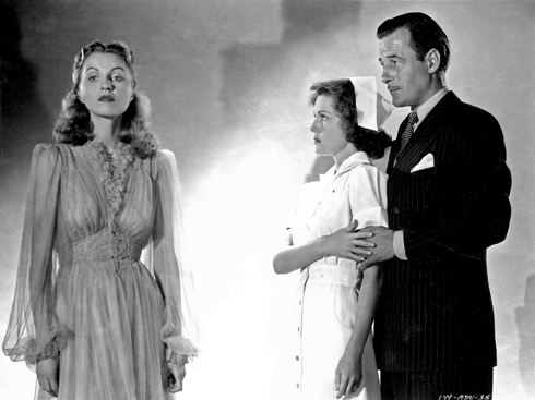 Betsy (Frances Dee) leaning against Paul (Tom Conway) as she stares at Jessica (Christine Gordon) who is staring at nothing.
