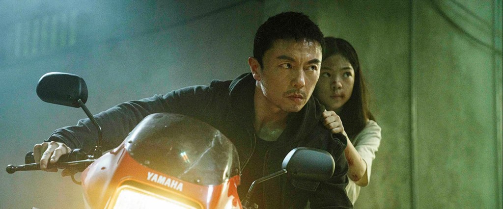 Dad (Xie Miao) on a motorcycle with Rainy (Enyou Yang) behind him. They both have determined expressions.