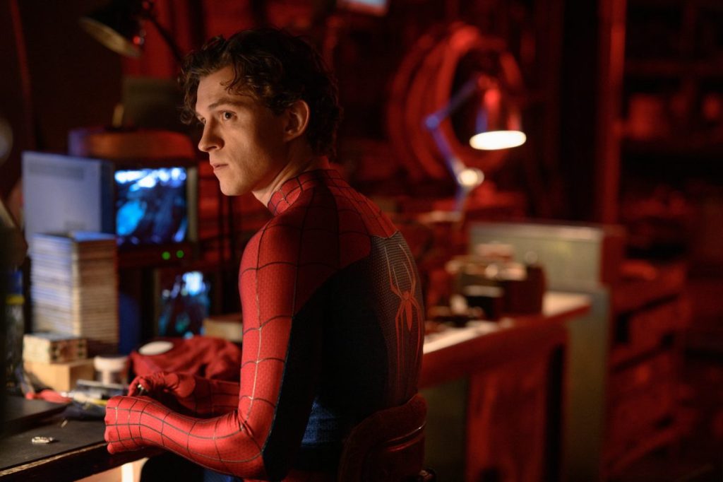 Spider-Man (Tom Holland) with his mask in his and and a serious expression.