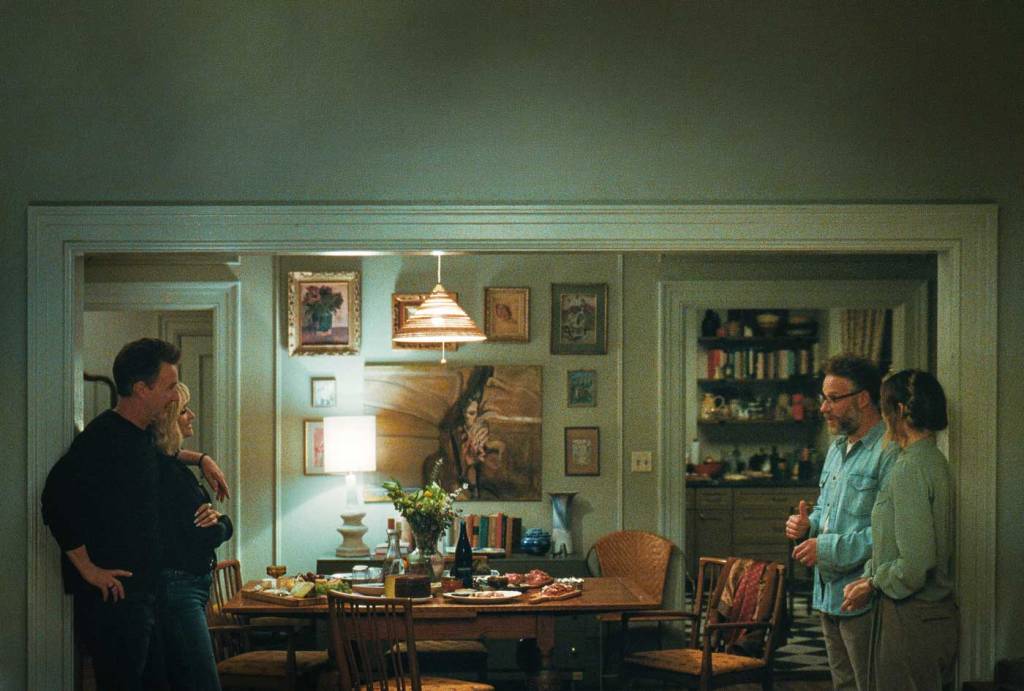 Hawk (Edward Norton) with his arm around Piña (Penélope Cruz) facing Joe (Seth Rogen) and Angela (Olivia Wilde). There is as much distance between the two couples as the room allows.